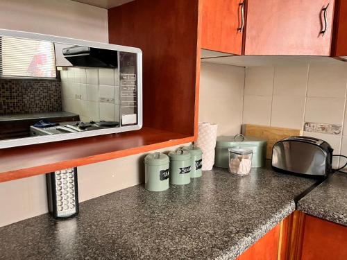 a kitchen with a counter top with a microwave at Your Home away from Home in Pinetown