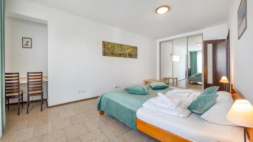 a bedroom with a bed and a dining room at Marea, Sun & Snow in Międzyzdroje