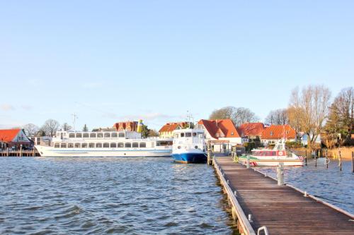 two boats docked at a dock in a harbor at hafennahe Ferienwohnung mit Balkon und Meerblick - Hafenhäuser Breege FeWo 11 in Breege