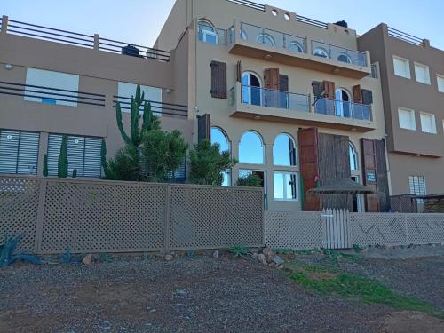 a house with a fence in front of it at Dar diafa samira in Mirleft