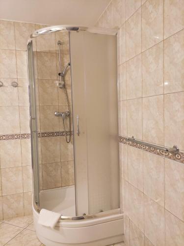a shower with a glass door in a bathroom at Panoramic-Oscar in Mrągowo