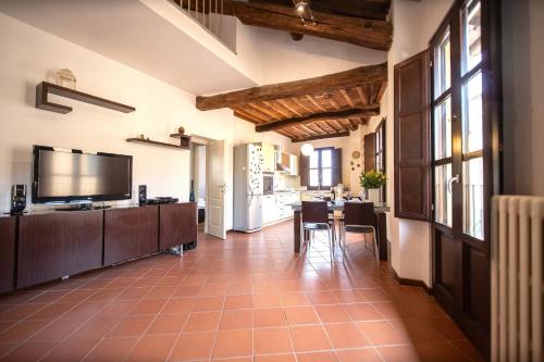 a large living room with a television and a table at Serena Apartment, Cosy Close Center Town in Lucca