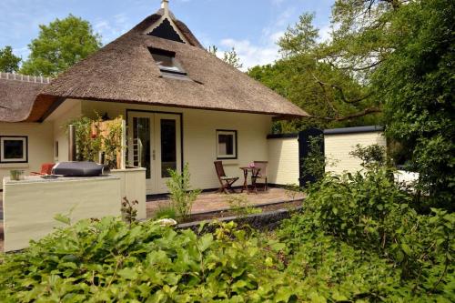 a small yellow house with a thatched roof at Hof van Yde in Yde