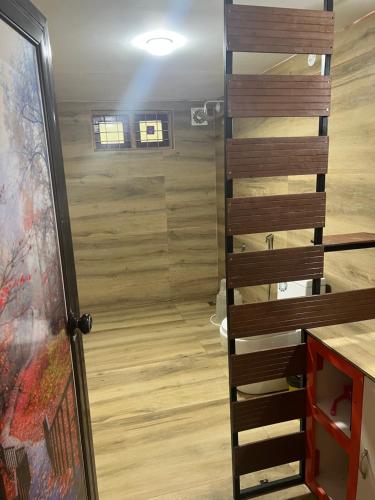 a stairway leading to a room with wooden floors at ARABIAN HOLIDAY RESORT WITH SWIMMING POOL IN IDUKKI Calvary Mount in Idukki