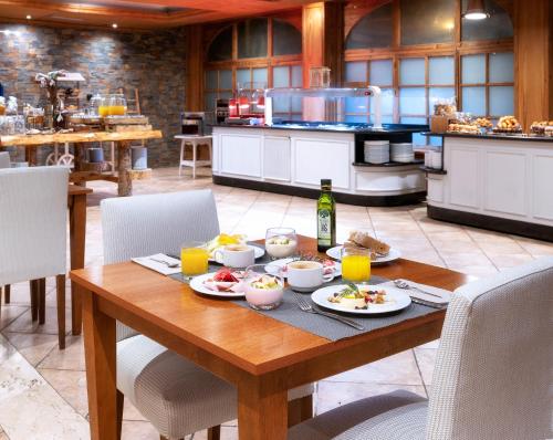 a wooden table with food on it in a kitchen at Hotel Vielha Val d'Aran, Affiliated by Meliá in Vielha