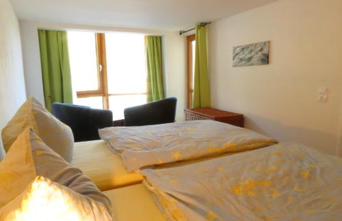 1 dormitorio con 2 camas individuales y ventana en Ferienwohnung Dobelblick, en Buchenbach