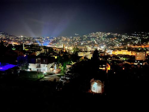 a view of a city at night with lights at The Penthouse Sarajevo in Sarajevo