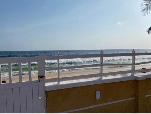 a gate to the beach with the ocean in the background at Oceanfront Wavecrest Hotel in Lekki