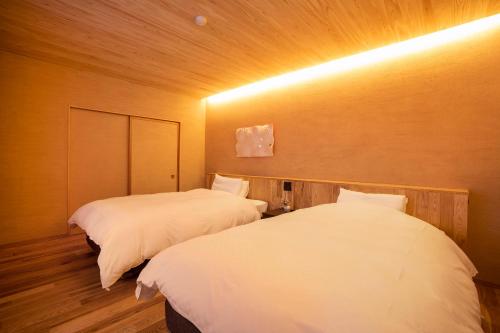 a room with two beds in a room at Ichiraku tendo spa & brewery in Tendo