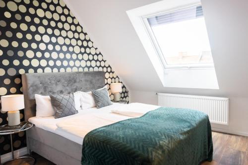 a bedroom with a large bed and a large window at THE Penthouse at Eco Smart Apartments in Nürnberg