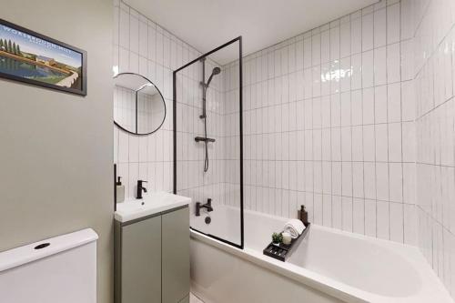 a bathroom with a tub and a sink and a shower at Oakwell View - Modern 3 Bed Home in Barnsley