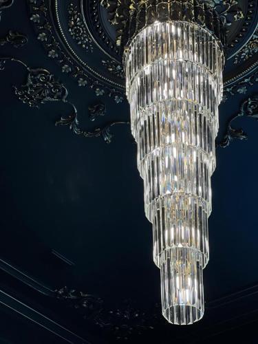 a large chandelier hanging from a ceiling at WIND HOTEL in Shymkent