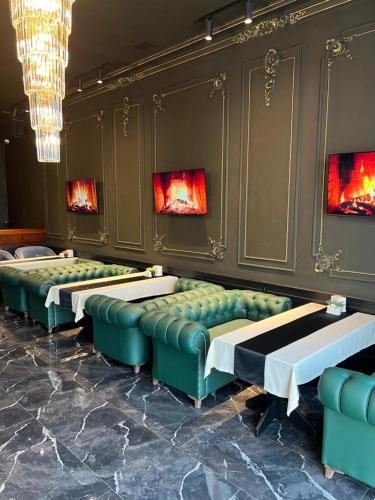 a room with a row of couches in a room at WIND HOTEL in Shymkent