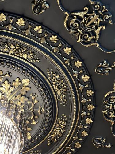 a black and gold plate on a wall at WIND HOTEL in Shymkent