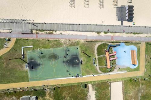 an aerial view of a tennis court in a field at Póvoa Beach Apartment in Póvoa de Varzim