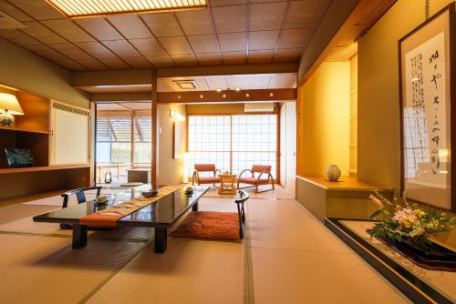 a large room with a table and chairs in it at Ichiraku tendo spa & brewery in Tendo