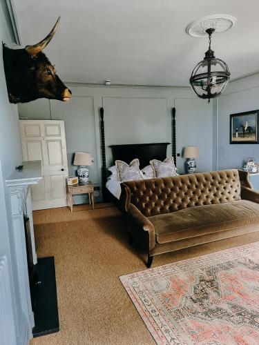 a bedroom with a bed with a deer head on the wall at Verzon House in Ledbury