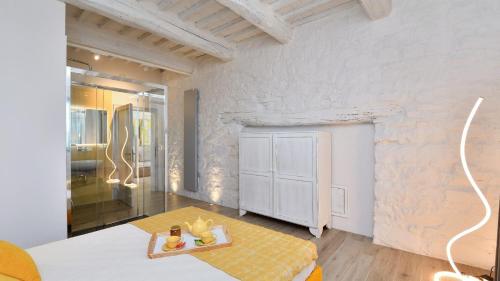 a bathroom with a shower and a table in a room at Ovile in Roccalbegna