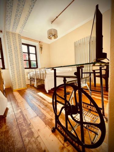 a room with a table and a room with a group of beds at HARABURDI® Recyclart Hotel in Kostelec nad Orlicí