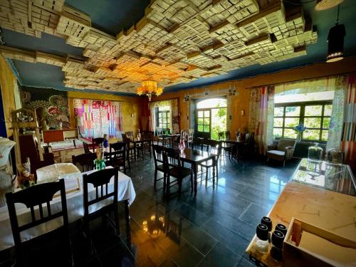 a restaurant with tables and chairs and a large ceiling at HARABURDI® Recyclart Hotel in Kostelec nad Orlicí