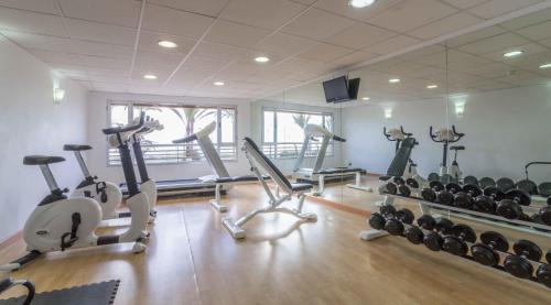 a gym with treadmills and exercise bikes in a room at Hotel Albahia Alicante in Alicante