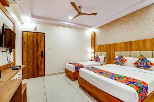a hotel room with two beds and a kitchen at FabHotel Rotano Grand - Nr Marathahalli Bridge in Bengaluru