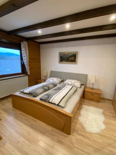 a bedroom with a large bed and a window at Feriendorf am Hohen Bogen Arrach Haus 69 OG in Arrach