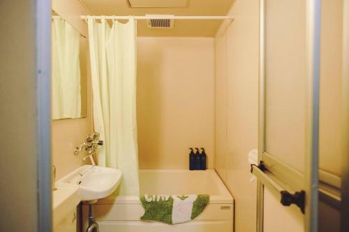 a small bathroom with a shower and a sink at *Beautiful, Sunny, & Quiet Apt Close to Metro in Tokyo