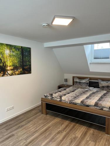 a bedroom with a bed and a painting on the wall at Mompels in Rübeland