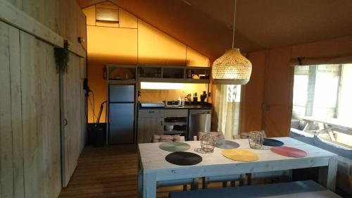 a kitchen with a table with plates on it at Camping Yn'e Lijte in Grou