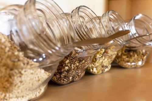 a row of glass jars filled with seeds on a table at Familiengasthof Schaller in Floß
