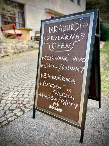 a chalkboard sign with writing on it on a street at HARABURDI® Recyclart Hotel in Kostelec nad Orlicí