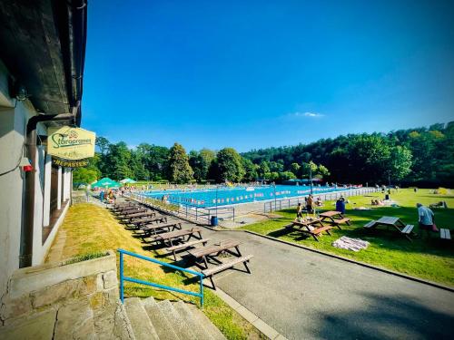 a swimming pool with a bunch of tables and chairs at HARABURDI® Recyclart Hotel in Kostelec nad Orlicí