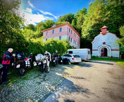 a group of motorcycles parked in front of a building at HARABURDI® Recyclart Hotel in Kostelec nad Orlicí