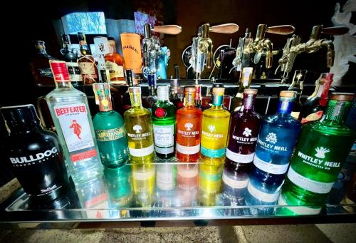 a bunch of different types of bottles on a bar at HARABURDI® Recyclart Hotel in Kostelec nad Orlicí