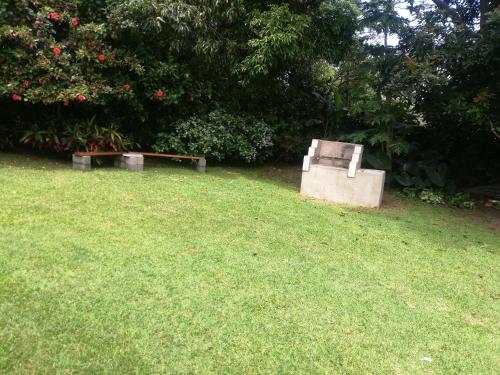 a bench sitting in the grass in a yard at Edward Cabana in Margate