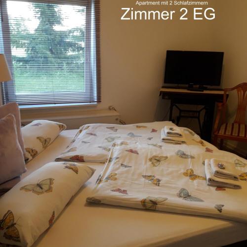 a bed with a comforter and pillows on it at Ferien Mecklenburgische Seenplatte, Urlaub auf dem Gutshof Bossow in Bossow
