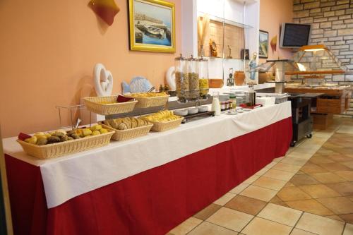 a buffet line with baskets of fruits and vegetables at Mediterranean Village San Antonio in Biograd na Moru