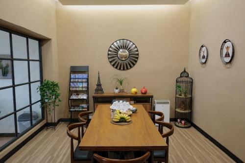 a dining room with a wooden table and chairs at 喜苑民宿 in Jinhu