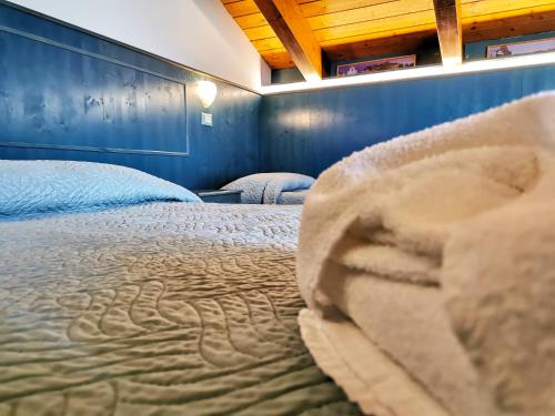 a bedroom with a bed and a blue wall at Hotel La Plage in Cattolica