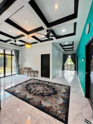 a large room with a large rug on the floor at Qs Family Homestay Pasir Mas in Pasir Mas