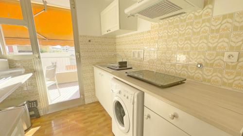 une cuisine avec une machine à laver sur un comptoir dans l'établissement La Couronne du Cros, à Cagnes-sur-Mer