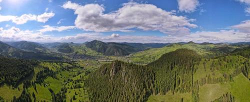 an aerial view of a green valley with mountains at Pensiunea Adam și Eva in Pojorîta