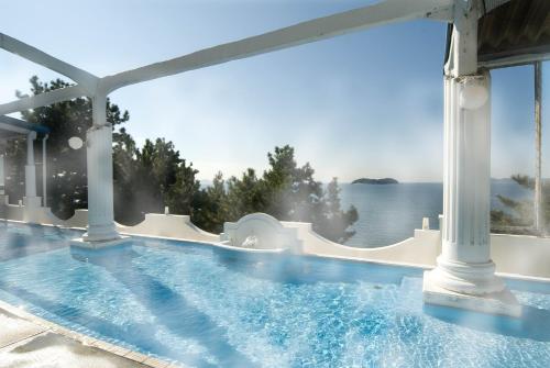 a swimming pool with a view of the water at Shofuen in Gamagori