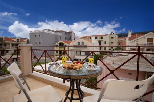 a balcony with a table and chairs on a balcony at City Suite in Kefalonia in Argostoli