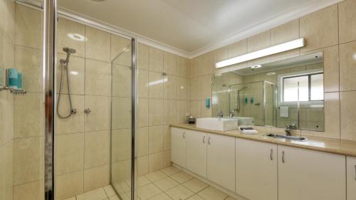 ein Bad mit einer Dusche und einem Waschbecken in der Unterkunft Motel Meneres in Corowa
