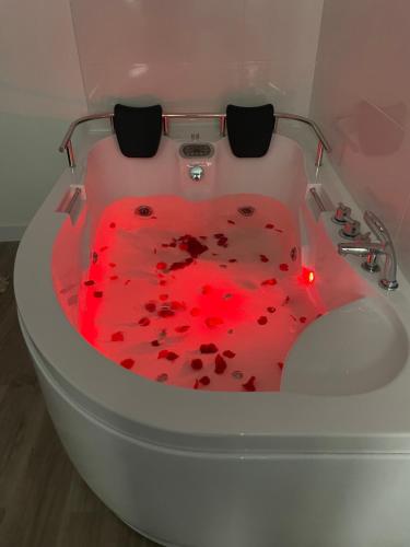a bath tub with a red heart in the middle at Bouzasol in Vigo
