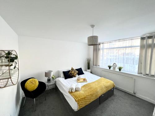 a bedroom with a bed and a window and a chair at 3 Cosy Homes Walking Distance to Mall with Parking Available to Book Separately 3 Bed House Or 1 Bed Apartment Or Studio in Golders Green