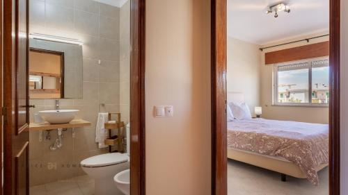 y baño con cama, lavabo y aseo. en T1 Grevilias em Vilamoura - Greice Homes en Quarteira