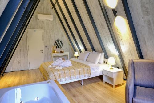 a bedroom with a bed and a bath tub at World DREAMS Sapanca in Sakarya